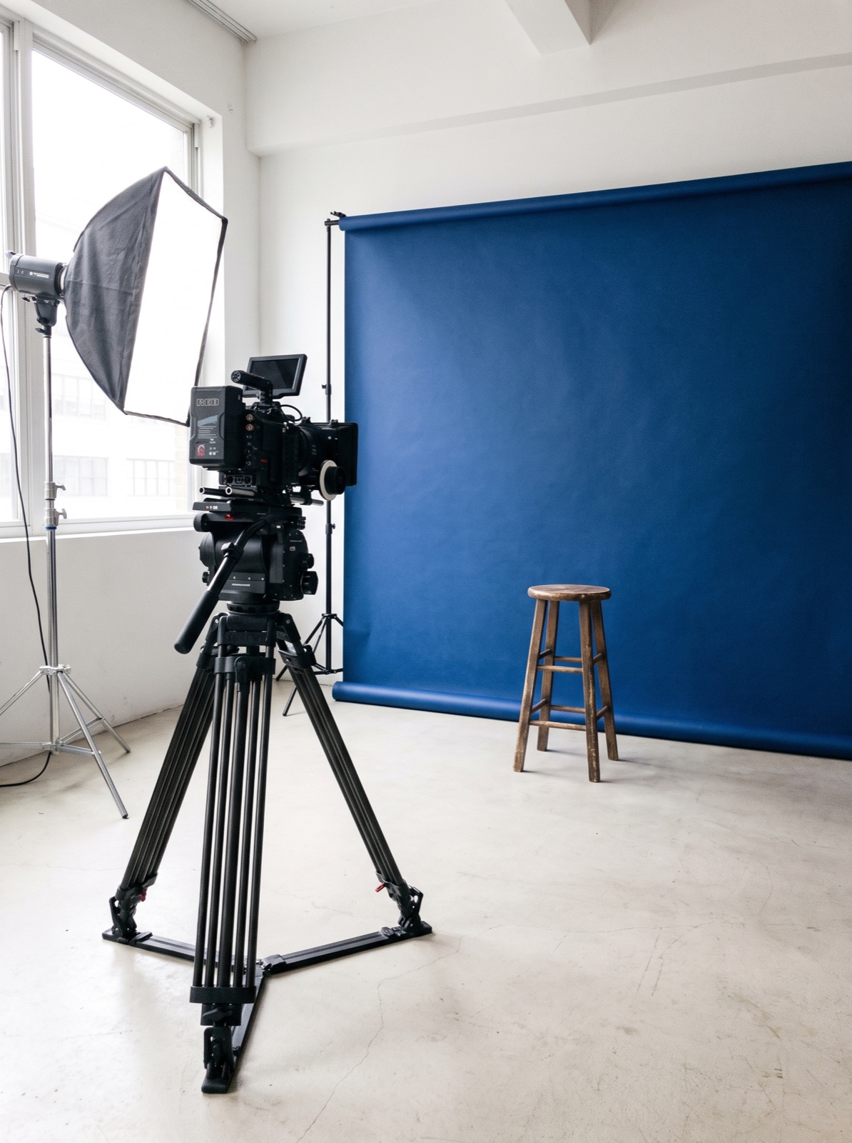 Studio set with a camera and a blue backdrop